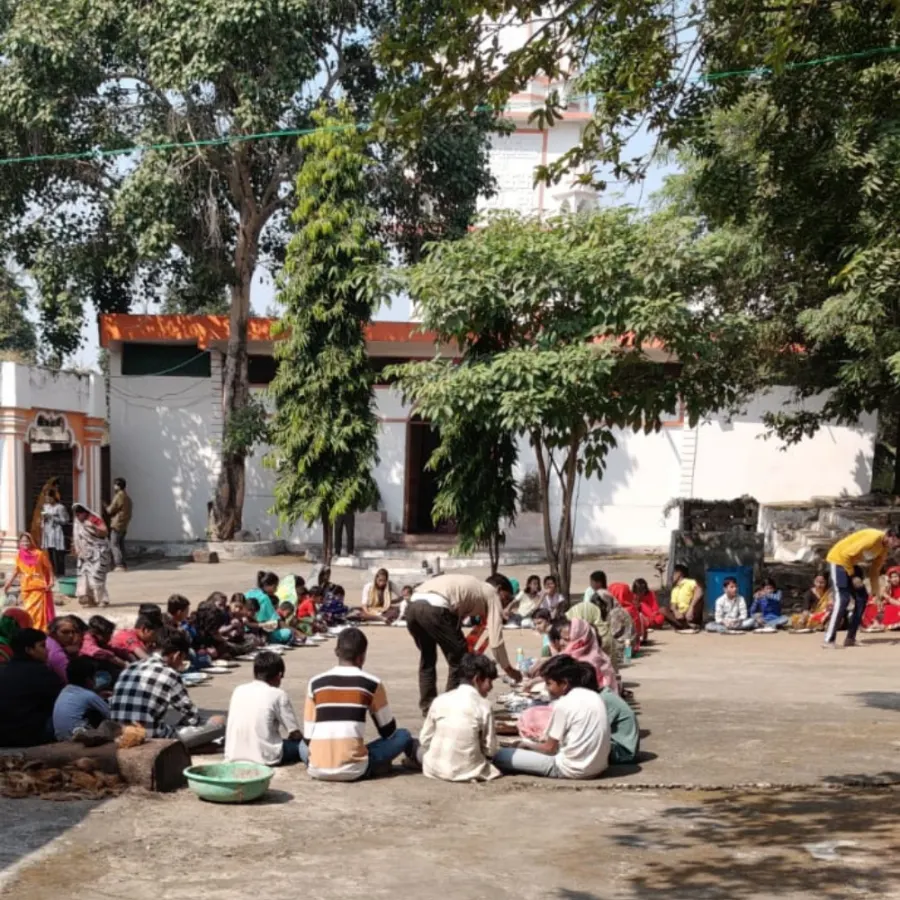 Community meal under the temple trees